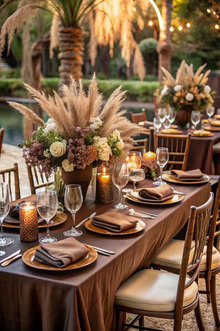 Round wedding table styled with burgundy napkins and a floral centerpiece by Reina Events, Malaa